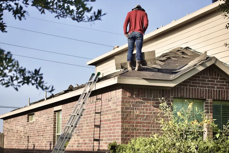 Professional roofer working on a residential roof in Southlake Town Square